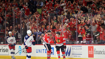 CHICAGO, IL - OCTOBER 07: Chicago Blackhawks right wing Patrick Kane (88) celebrates with Chicago Blackhawks defenseman Jan Rutta (44) and fans after scoring a goal during a game between the Chicago Blackhawks and the Columbus Blue Jackets on October 7, 2017, at the United Center in Chicago, IL.