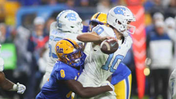 North Carolina Tar Heels Drake Maye (10) gets sacked by Pittsburgh Panthers Samuel Okunlola (8) during the first half at Acrisure Stadium in Pittsburgh, PA on September 23, 2023.
