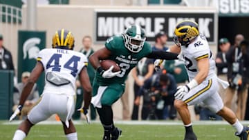 EAST LANSING, MI - OCTOBER 29: LJ Scott #3 of the Michigan State Spartans runs for a first down during the first quarter of the game against the Michigan Wolverines at Spartan Stadium on October 29, 2016 in East Lansing, Michigan. (Photo by Leon Halip/Getty Images)