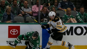 DALLAS, TX - OCTOBER 03: Dallas Stars center Andrew Cogliano (11) and Boston Bruins center Karson Kuhlman (83) chase the puck during the game between the Dallas Stars and the Boston Bruins on October 03, 2019 at American Airlines Center in Dallas, Texas. (Photo by Matthew Pearce/Icon Sportswire via Getty Images)