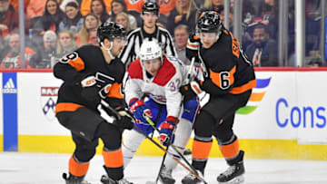 Feb 24, 2023; Philadelphia, Pennsylvania, USA; Montreal Canadiens center Rem Pitlick (32) battles for the puck Philadelphia Flyers left wing Noah Cates (49) and defenseman Travis Sanheim (6) during the third period at Wells Fargo Center. Mandatory Credit: Eric Hartline-USA TODAY Sports