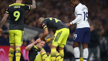 LONDON, ENGLAND - FEBRUARY 05: James Ward-Prowse of Southampton reacts as he goes down injured and is checked on by his teammates and Ryan Sessegnon of Tottenham Hotspur during the FA Cup Fourth Round Replay match between Tottenham Hotspur and Southampton FC at Tottenham Hotspur Stadium on February 05, 2020 in London, England. (Photo by Julian Finney/Getty Images)