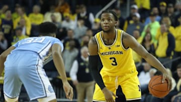 ANN ARBOR, MI - NOVEMBER 28: Zavier Simpson #3 of the Michigan Wolverines watches the clock as K.J. Smith #30 of the North Carolina Tar Heels defends during the second half of the game at Crisler Center on November 28, 2018 in Ann Arbor, Michigan. Michigan defeated North Carolina Tar Heels 84-67. (Photo by Leon Halip/Getty Images)