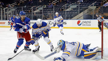 Mar 2, 2021; New York, New York, USA; Buffalo Sabres goaltender Carter Hutton (40) makes a save against New York Rangers left wing Chris Kreider (20) during the third period at Madison Square Garden. The Rangers won 3-2. Mandatory Credit: Bruce Bennett-POOL PHOTOS-USA TODAY Sports