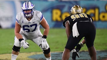 BOCA RATON, FLORIDA - DECEMBER 22: (L-R) Blake Freeland #71, Chandon Herring #77, Connor Pay #70, and Tristen Hoge #69 of the Brigham Young Cougars celebrate a touchdown in the first half against the Central Florida Knights at FAU Stadium on December 22, 2020 in Boca Raton, Florida. (Photo by Mark Brown/Getty Images)