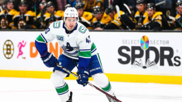 BOSTON, MA - FEBRUARY 04: Quinn Hughes #43 of the Vancouver Canucks skates with the puck during a game against the Boston Bruins at TD Garden on February 4, 2020 in Boston, Massachusetts. (Photo by Adam Glanzman/Getty Images)