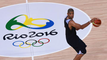 Nicolas Batum of France runs past the 'Rio 2016' logo during a training session for the French men's basketball team ahead of the Rio 2016 Olympic Games, at the Olympic Park in Rio de Janeiro, on August 3, 2016. / AFP / Mark RALSTON (Photo credit should read MARK RALSTON/AFP/Getty Images)