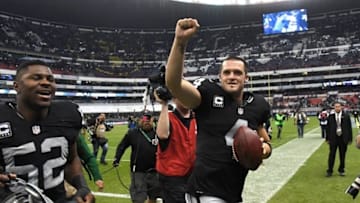 Nov 21, 2016; Mexico City, MEX; Oakland Raiders quarterback Derek Carr (4) and linebacker Khalil Mack (52) celebrate after a NFL International Series game against the Houston Texans at Estadio Azteca. The Raiders defeated the Texans 27-20. Mandatory Credit: Kirby Lee-USA TODAY Sports