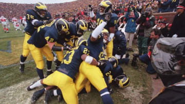 Michigan cornerback Charles Woodson is mobbed by celebrating teammates after his 2nd quarter punt return for a touchdown against Ohio State University on Saturday, Nov 22, at Michigan Stadium in Ann Arbor, MI. Syndication: DetroitFreePress