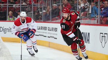 GLENDALE, ARIZONA - OCTOBER 30: Derek Stepan #21 of the Arizona Coyotes skates with the puck ahead of Paul Byron #41 of the Montreal Canadiens during the NHL game at Gila River Arena on October 30, 2019 in Glendale, Arizona. The Canadiens defeated the Coyotes 4-1. (Photo by Christian Petersen/Getty Images)