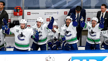 The Vancouver Canucks react. (Photo by Bruce Bennett/Getty Images)