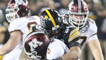 IOWA CITY, IOWA- NOVEMBER 16: Defensive end A.J. Epenesa #94 of the Iowa Hawkeyes makes a sack during the second half on quarterback Tanner Morgan #2 of the Minnesota Gophers on November 16, 2019 at Kinnick Stadium in Iowa City, Iowa. (Photo by Matthew Holst/Getty Images)