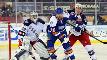 Jan 29, 2014; New York City, NY, USA; New York Islanders left wing Thomas Vanek (26) battles for position between New York Rangers goalie Henrik Lundqvist (30) and defenseman Ryan McDonagh (27) in the first period during the Stadium Series hockey game at Yankee Stadium. Mandatory Credit: Ed Mulholland-USA TODAY Sports