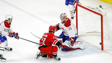 The Carolina Hurricanes' Brock McGinn (23) scores against the Montreal Canadiens' Jonathan Drouin (92) and Carey Price (31) during the third period at PNC Arena in Raleigh, N.C., on Thursday, Feb. 1, 2018. The Canes won, 2-0. (Chris Seward/Raleigh News & Observer/TNS via Getty Images)