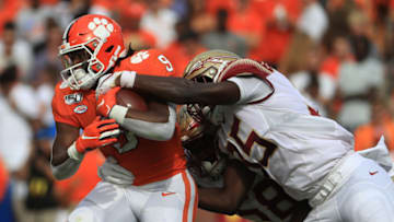 CLEMSON, SOUTH CAROLINA - OCTOBER 12: Leonard Warner III #35 of the Florida State Seminoles tries to stop Travis Etienne #9 of the Clemson Tigers during their game at Memorial Stadium on October 12, 2019 in Clemson, South Carolina. (Photo by Streeter Lecka/Getty Images)