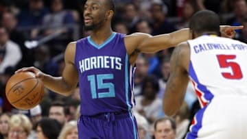 Mar 25, 2016; Auburn Hills, MI, USA; Charlotte Hornets guard Kemba Walker (15) points with the ball against Detroit Pistons guard Kentavious Caldwell-Pope (5) during the first quarter at The Palace of Auburn Hills. Mandatory Credit: Raj Mehta-USA TODAY Sports