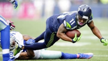 Oct 12, 2014; Seattle, WA, USA; Seattle Seahawks wide receiver Percy Harvin (11) dives for extra yards while being tackled by Dallas Cowboys cornerback Orlando Scandrick (32) during the first half at CenturyLink Field. Mandatory Credit: Steven Bisig-USA TODAY Sports