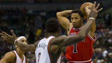 Nov 5, 2014; Milwaukee, WI, USA; Chicago Bulls guard Derrick Rose (1) passed the ball as Milwaukee Bucks center Larry Sanders (8) defends during the second quarter at BMO Harris Bradley Center. Mandatory Credit: Jeff Hanisch-USA TODAY Sports