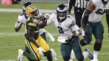 Dec 6, 2020; Green Bay, Wisconsin, USA; Philadelphia Eagles quarterback Jalen Hurts (2) scrambles in the third quarter against the Green Bay Packers at Lambeau Field. Mandatory Credit: Benny Sieu-USA TODAY Sports