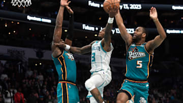 Charlotte Hornets guard Terry Rozier (3) drives in as he is defended by Detroit Pistons center Jalen Duren (0) and guard Alec Burks (5) Credit: Sam Sharpe-USA TODAY Sports