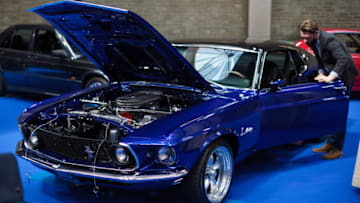 LONDON, ENGLAND - APRIL 11: A man inspects a 1969 Ford Mustang Mach 1(estimate £38,000 - £42,000) inside the Royal Horticultural Halls on April 11, 2017 in London, England. Coys automobile auctioneers are putting almost 70 classic cars up for auction in their Spring Classics sale in Westminster tomorrow, April 12, 2017. (Photo by Jack Taylor/Getty Images)