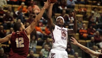 Jan 11, 2014; Blacksburg, VA, USA; Virginia Tech Hokies guard Ben Emelogu (15) shoots the ball against Boston College Eagles forward Ryan Anderson (12) during the second half at Cassell Coliseum. Mandatory Credit: Peter Casey-USA TODAY Sports