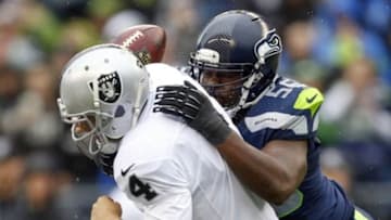 Nov 2, 2014; Seattle, WA, USA; Seattle Seahawks defensive end Cliff Avril (56) forces a fumble by Oakland Raiders quarterback Derek Carr (4) during the second quarter at CenturyLink Field. Mandatory Credit: Joe Nicholson-USA TODAY Sports
