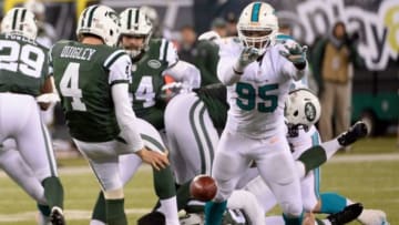 Dec 1, 2014; East Rutherford, NJ, USA; Miami Dolphins defensive end Dion Jordan (95) blocks a punt by New York Jets punter Ryan Quigley (4) during the second half at MetLife Stadium. Mandatory Credit: Robert Deutsch-USA TODAY Sports
