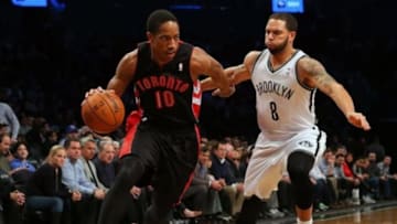 Mar 10, 2014; Brooklyn, NY, USA; Toronto Raptors shooting guard DeMar DeRozan (10) drives past Brooklyn Nets point guard Deron Williams (8) during the first quarter at the Barclays Center. Mandatory Credit: Adam Hunger-USA TODAY Sports