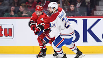 MONTREAL, QC - DECEMBER 13: Carolina Hurricanes center Sebastian Aho (20) tries to stop Montreal Canadiens center Phillip Danault (24) during the Carolina Hurricanes versus the Montreal Canadiens game on December 13, 2018, at Bell Centre in Montreal, QC (Photo by David Kirouac/Icon Sportswire via Getty Images)