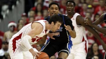 Dec 3, 2014; Madison, WI, USA; Wisconsin Badgers forward Frank Kaminsky (44) moves the ball against Duke Blue Devils center Jahlil Okafor (15) defends during the first half at the Kohl Center. Mandatory Credit: Mary Langenfeld-USA TODAY Sports