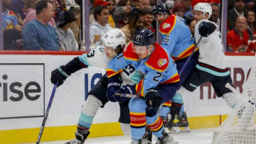 Dec 11, 2022; Sunrise, Florida, USA; Seattle Kraken left wing Brandon Tanev (13) protects the puck from Florida Panthers center Nick Cousins (21) during the second period at FLA Live Arena. Mandatory Credit: Sam Navarro-USA TODAY Sports