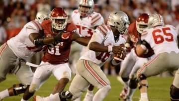 Sep 17, 2016; Norman, OK, USA; Ohio State Buckeyes quarterback J.T. Barrett (16) runs the ball past Oklahoma Sooners linebacker Ogbonnia Okoronkwo (31) in the fourth quarter at Gaylord Family - Oklahoma Memorial Stadium. Mandatory Credit: Mark D. Smith-USA TODAY Sports