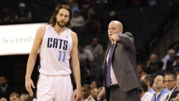 Mar 10, 2014; Charlotte, NC, USA; Charlotte Bobcats head coach Steve Clifford talks to forward Josh McRoberts (11) during the second half of the game against the Denver Nuggets at Time Warner Cable Arena. Bobcats win 105-98. Mandatory Credit: Sam Sharpe-USA TODAY Sports