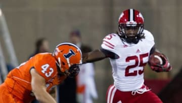 Oct 19, 2013; Champaign, IL, USA; Wisconsin Badgers running back Melvin Gordon (25) runs against Illinois Fighting Illini linebacker Mason Monheim (43) during the game at Memorial Stadium. Wisconsin wins 56-32 over Illinois. Mandatory Credit: Trevor Ruszkowksi-USA TODAY Sports