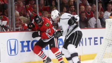 May 28, 2014; Chicago, IL, USA; Chicago Blackhawks defenseman Johnny Oduya (27) battles for the puck with Los Angeles Kings right wing Justin Williams (14) during the third period in game five of the Western Conference Final of the 2014 Stanley Cup Playoffs at United Center. Mandatory Credit: Jerry Lai-USA TODAY Sports