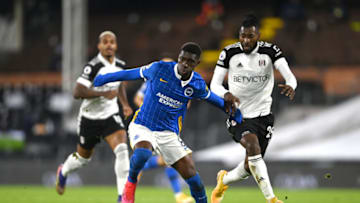 LONDON, ENGLAND - DECEMBER 16: Yves Bissouma of Brighton and Hove Albion runs with the ball under pressure from Andre-Frank Zambo Anguissa of Fulham during the Premier League match between Fulham and Brighton & Hove Albion at Craven Cottage on December 16, 2020 in London, England. The match will be played without fans, behind closed doors as a Covid-19 precaution. (Photo by Mike Hewitt/Getty Images)