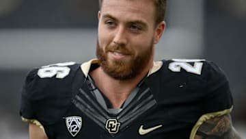 BOULDER, CO - NOVEMBER 20: Linebacker Carson Wells #26 of the Colorado Buffaloes walks onto the field during a ceremony to honor graduating seniors before a game against the Washington Huskies at Folsom Field on November 20, 2021 in Boulder, Colorado. (Photo by Dustin Bradford/Getty Images)