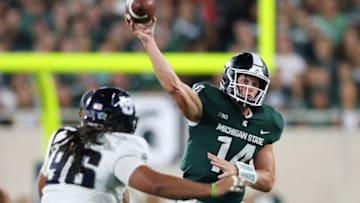 EAST LANSING, MI - AUGUST 31: Brian Lewerke #14 of the Michigan State Spartans throws a fourth quarter pass over Christopher 'Unga #96 of the Utah State Aggies at Spartan Stadium on August 31, 2018 in East Lansing, Michigan State won the game 38-31. Michigan. (Photo by Gregory Shamus/Getty Images)