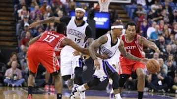 Dec 15, 2013; Sacramento, CA, USA; Houston Rockets shooting guard James Harden (13) fouls Sacramento Kings point guard Isaiah Thomas (22) during the fourth quarter at Sleep Train Arena. The Sacramento Kings defeated the Houston Rockets 106-91. Mandatory Credit: Kelley L Cox-USA TODAY Sports