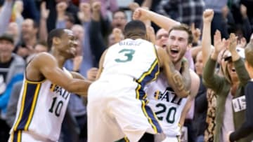 Nov 5, 2014; Salt Lake City, UT, USA; Utah Jazz guard Gordon Hayward (20) and guard Trey Burke (3) and guard Alec Burks (10) react to defeating the Cleveland Cavaliers 102-100 at EnergySolutions Arena. Mandatory Credit: Russ Isabella-USA TODAY Sports