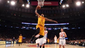 Mar 26, 2016; New York, NY, USA; Cleveland Cavaliers shooting guard J.R. Smith (5) dunks past New York Knicks small forward Carmelo Anthony (7) and New York Knicks shooting guard Sasha Vujacic (18) during the second half at Madison Square Garden. Mandatory Credit: Brad Penner-USA TODAY Sports