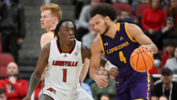 Dec 20, 2022; Louisville, Kentucky, USA; Lipscomb Bisons guard Derrin Boyd (4) dribbles against Louisville Cardinals guard Mike James (1) during the second half at KFC Yum! Center. Lipscomb defeated Louisville 75-67. Mandatory Credit: Jamie Rhodes-USA TODAY Sports