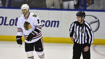 Apr 19, 2014; St. Louis, MO, USA; Chicago Blackhawks defenseman Brent Seabrook (7) is escorted off the ice by linesman Brad Kovachik (71) with a 5 minute penalty and a game misconduct after after a hit on St. Louis Blues center David Backes (not pictured) during the third period in game two of the first round of the 2014 Stanley Cup Playoffs at Scottrade Center. Mandatory Credit: Scott Rovak-USA TODAY Sports