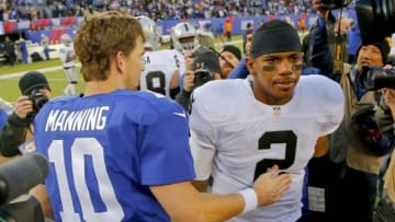 Nov 10, 2013; East Rutherford, NJ, USA; New York Giants quarterback Eli Manning (10) and Oakland Raiders quarterback Terrelle Pryor (2) after the game at MetLife Stadium. New York Giants defeat the Oakland Raiders 24-20. Mandatory Credit: Jim O