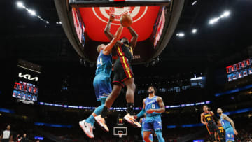 ATLANTA, GA - APRIL 13: Clint Capela #15 of the Atlanta Hawks dunks against Mason Plumlee #24 of the Charlotte Hornets during the first half at State Farm Arena on April 13, 2022 in Atlanta, Georgia. NOTE TO USER: User expressly acknowledges and agrees that, by downloading and or using this photograph, User is consenting to the terms and conditions of the Getty Images License Agreement. (Photo by Todd Kirkland/Getty Images)