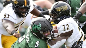 CHARLOTTE, NC - OCTOBER 27: Defensive end Alex Highsmith #5 of the Charlotte 49ers tackles running back Trivenskey Mosley #22 of the Southern Miss Golden Eagles during the football game at Jerry Richardson Stadium on October 27, 2018 in Charlotte, North Carolina. (Photo by Mike Comer/Getty Images)