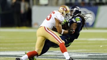 Sep 15, 2013; Seattle, WA, USA; San Francisco 49ers free safety Eric Reid (35) tackles Seattle Seahawks wide receiver Sidney Rice (18) during the 1st half at CenturyLink Field. Reid suffered a concussion in this game, what Dr. Garza helped determine for the team. Mandatory Credit: Steven Bisig-USA TODAY Sports