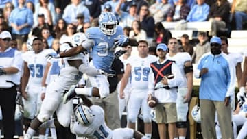 Nov 19, 2016; Chapel Hill, NC, USA; North Carolina Tar Heels running back Elijah Hood (34) with the ball as Citadel Bulldogs linebacker Myles Pierce (50) and defensive back Ben Roberts (11) defend in the first quarter at Kenan Memorial Stadium. Mandatory Credit: Bob Donnan-USA TODAY Sports