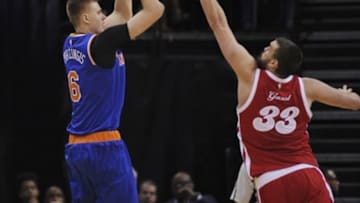 Jan 16, 2016; Memphis, TN, USA; New York Knicks forward Kristaps Porzingis (6) shoots over Memphis Grizzlies center Marc Gasol (33) during the second half at FedExForum. Memphis Grizzlies defeated the New York Knicks 103-95. Mandatory Credit: Justin Ford-USA TODAY Sports